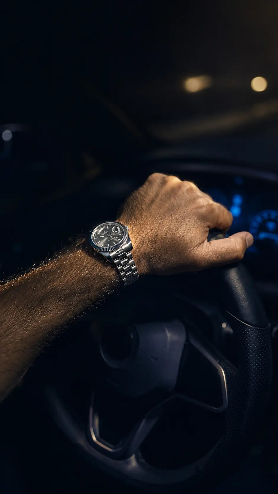 MQ watch on the wrist at a steering wheel